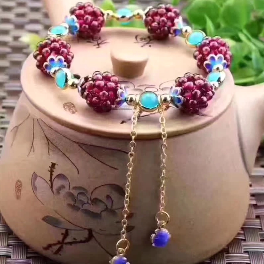Pink accent garnet amethyst Buddhist healing bracelet with handcrafted details and adjustable sizing