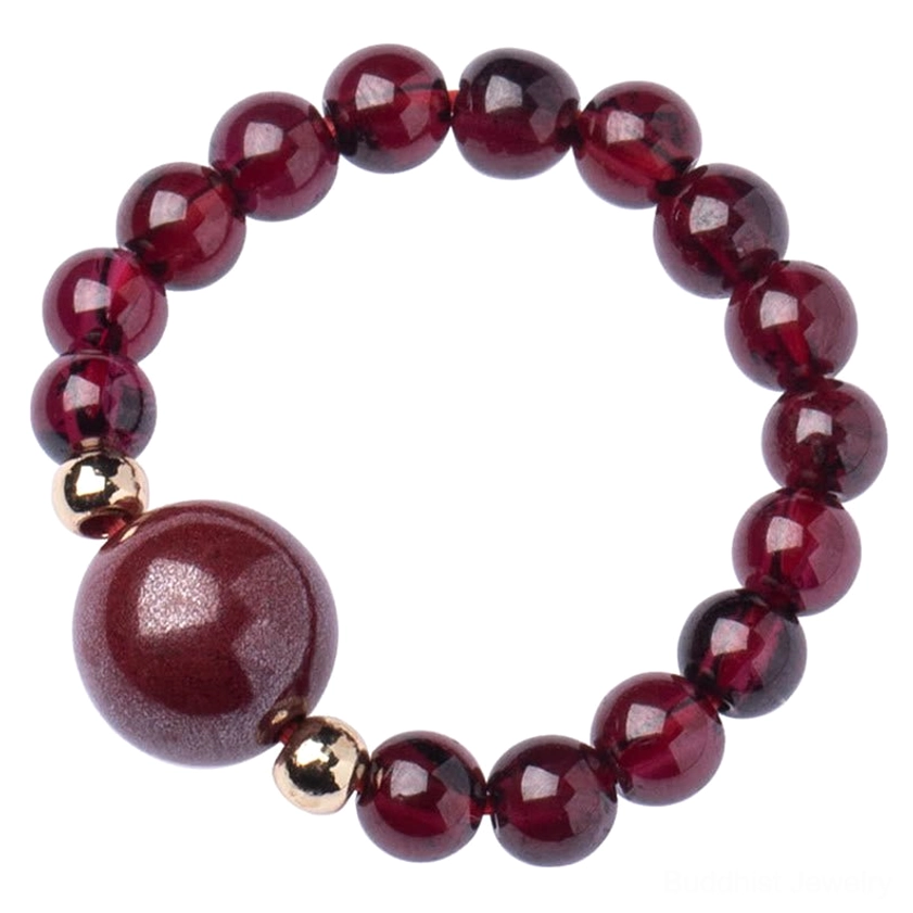 Large focal bead garnet cinnabar Buddhist bracelet with smooth burgundy round beads, polished cinnabar centerpiece, and gold tone spacer beads on wine-red background