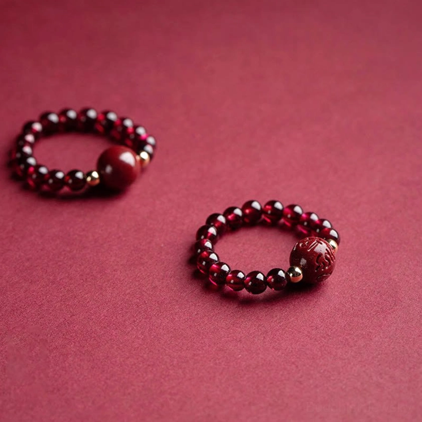 Natural garnet cinnabar Buddhist protection ring with intricate hand-carved details, burgundy stone beads, and spiritual charm accents for daily meditation wear