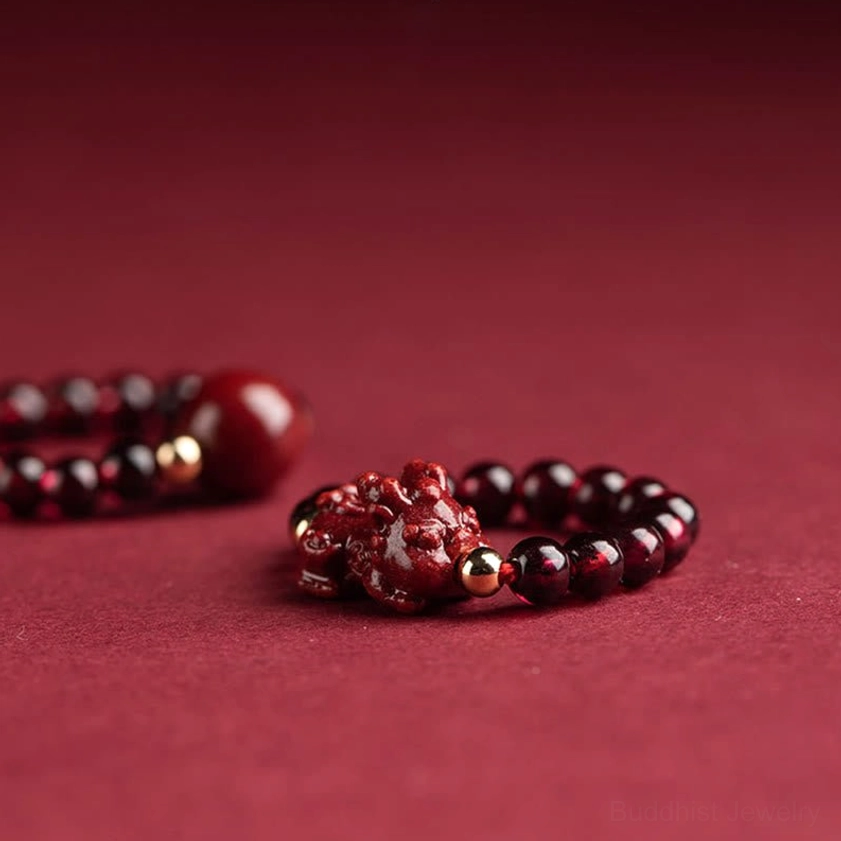Garnet cinnabar Buddhist ring with Om Mani Padme Hum mantra engraving, PiXiu wealth protection charm, and hand-carved burgundy beads detail view