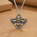 Garuda Bird copper Buddhist protection pendant necklace flat lay top view with wheat chain