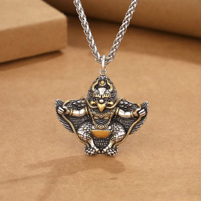 Garuda Bird copper Buddhist protection pendant necklace flat lay top view with wheat chain