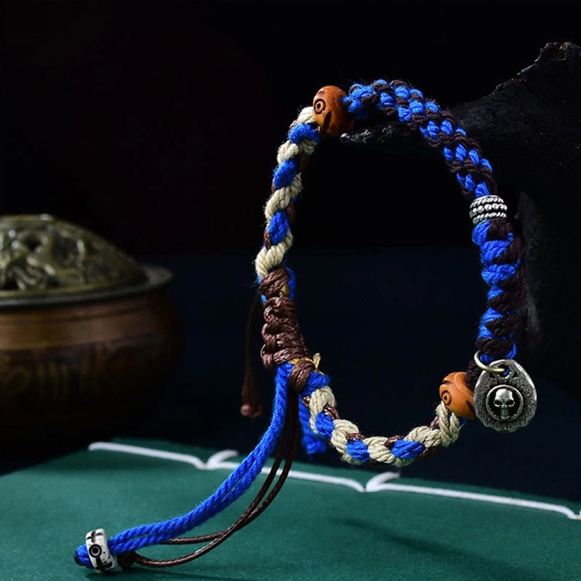 Blue Buddhist Garuda bracelet side view with detailed weaving knots, mixed blue braided design, and wooden beads