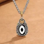 Garuda Dzi bead copper necklace pendant with hand-painted eye pattern and vintage scroll border on brown kraft paper background