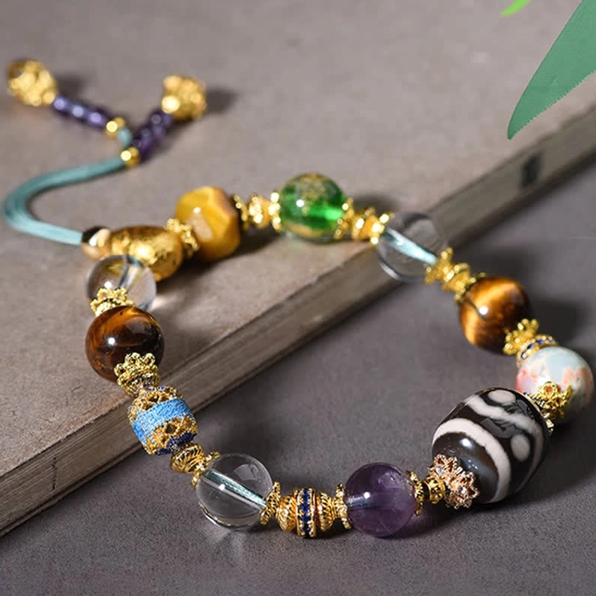 Mixed gemstone Buddhist bracelet showing texture and color harmony of Dzi bead amethyst and tiger eye stones