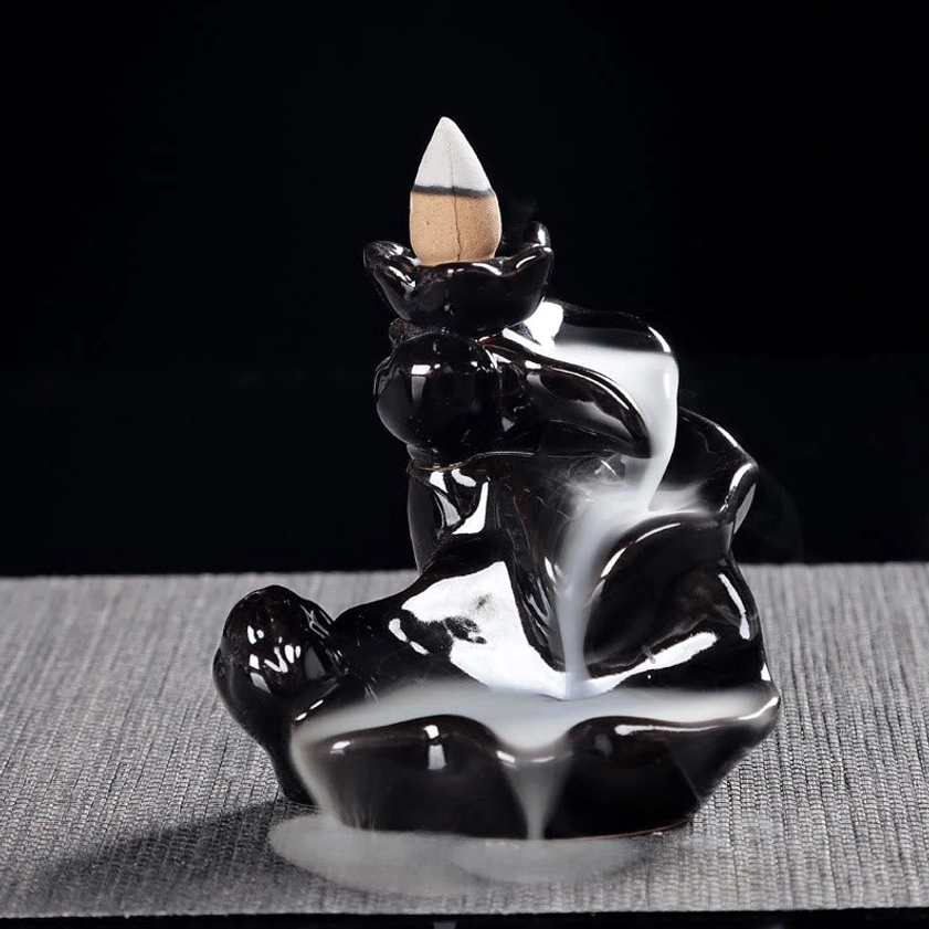 Premium ceramic backflow incense holder with smooth glossy black finish, right angled perspective