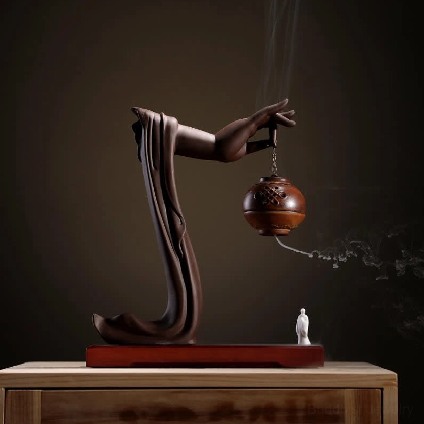 Handmade glossy brown spherical incense burner Buddhist hand design with smoke