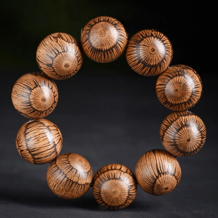 Gnetum wood Buddhist protection bracelet with deeper brown color and prominent radial striped grain pattern