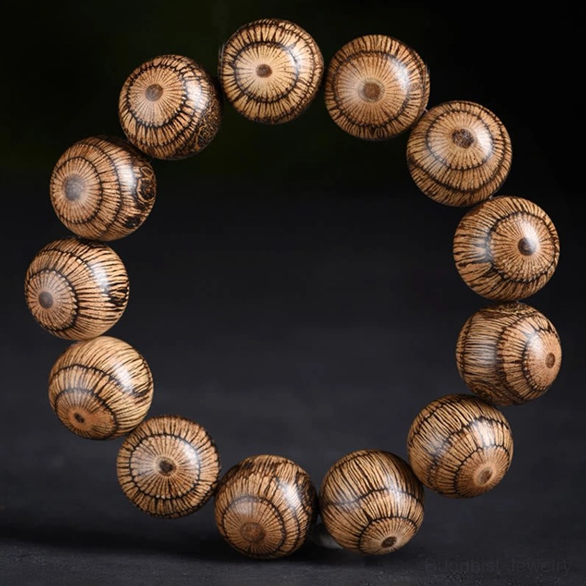 Full gnetum wood Buddhist bracelet flat lay showing symmetrical design with natural striped wood grain pattern throughout