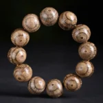Gnetum wood beads Buddhist bracelet for protection - flat lay top view showing radial grain pattern on natural wood beads