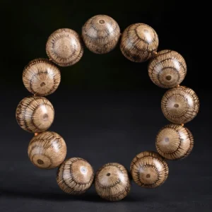 Gnetum wood beads Buddhist bracelet for protection - flat lay top view showing radial grain pattern on natural wood beads