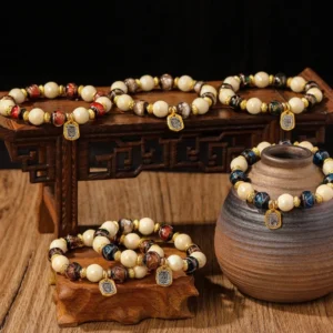 Goddess of Wealth liuli glass and incense ash porcelain bead bracelets displayed on carved wooden stands with pottery decor