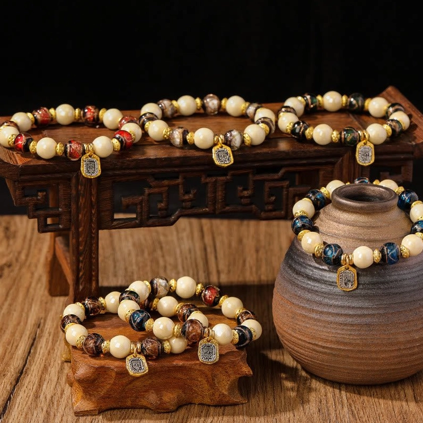 Goddess of Wealth liuli glass and incense ash porcelain bead bracelets displayed on carved wooden stands with pottery decor