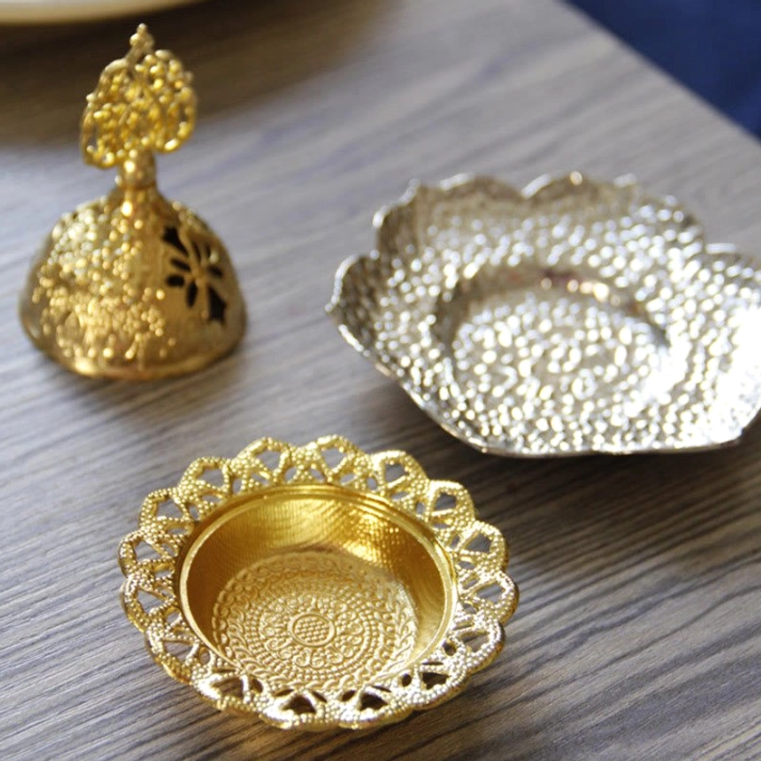 Gold alloy incense burner with intricate hollow-cut design for meditation room ambiance