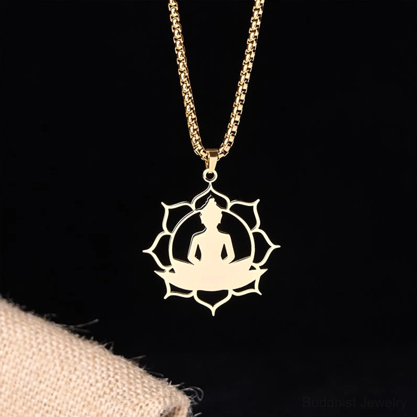 Gold buddha lotus pendant necklace hanging dark background spiritual jewelry