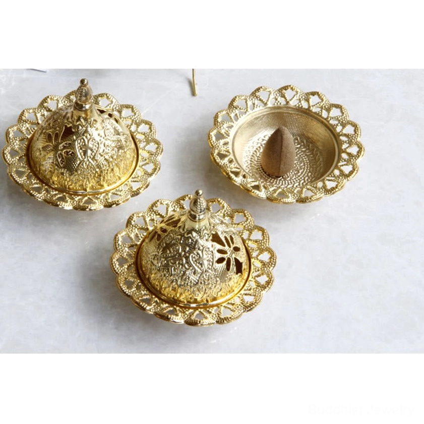 Complete set of three gold Buddhist incense burners with carved floral patterns on lids and cone incense