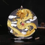 Gold dragon ceramic backflow incense burner with flowing smoke and white cloud patterns on home desk