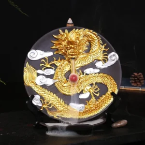Gold dragon ceramic backflow incense burner with flowing smoke and white cloud patterns on home desk