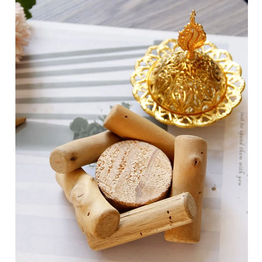 Gold alloy incense burner with burning incense cone releasing fragrant smoke - aroma therapy setting