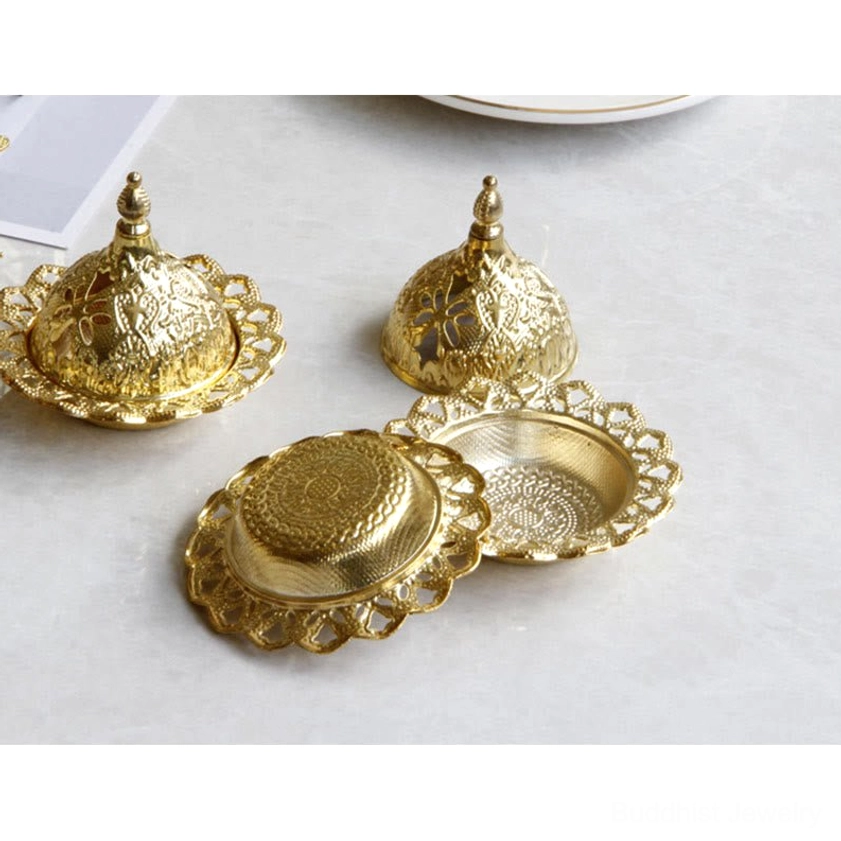 Flat overhead view of gold incense burner set showing two lidded burners with one disassembled tray and base