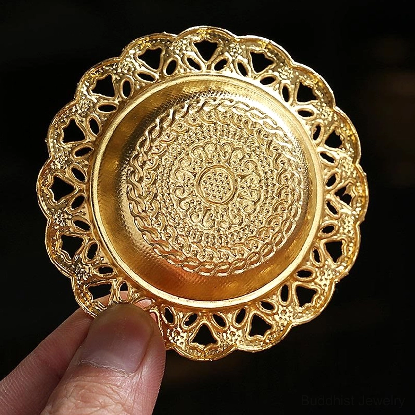 Close-up of gold incense holder tray showing mandala embossed center and lace hollow edge detail