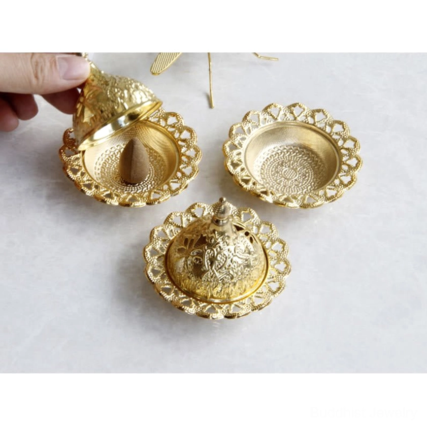 Elegant gold incense holder with intricate carved details perfect for yoga room or meditation space