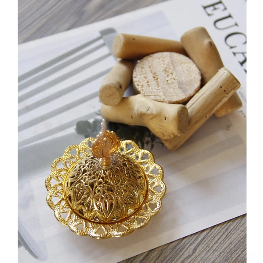 Gold hollow carved incense tray with natural wooden stand and round coaster base - flat overhead view