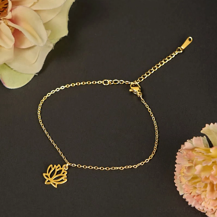 Gold tone lotus charm bracelet with polished cable chain and adjustable clasp