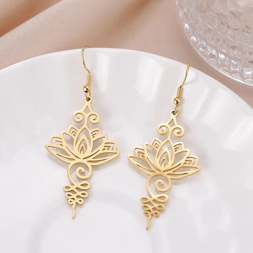 Gold hollow lotus flower drop earrings with filigree scroll ornament Buddhist enlightenment design