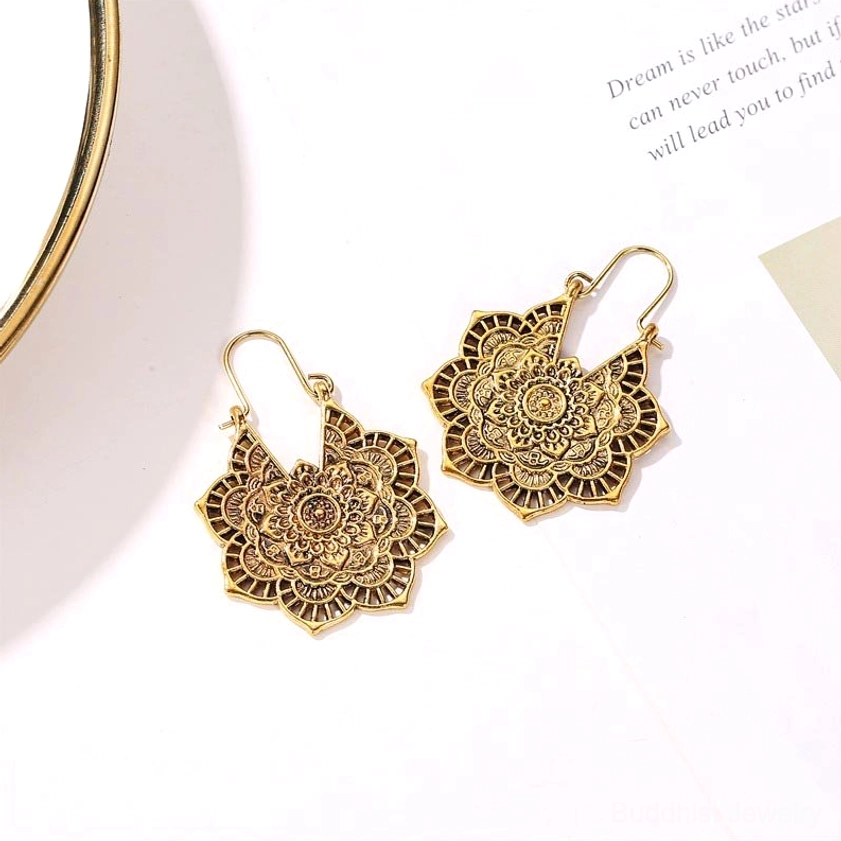 Gold filigree lotus drop earrings with vintage boho style, oblique angle showing intricate hollow pattern and hoop earwire