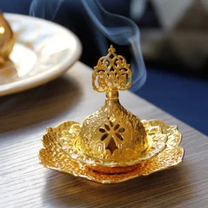 Gold lotus leaf Buddhist incense burner with carved hollow lid and flower-shaped tray, overhead view with burning incense