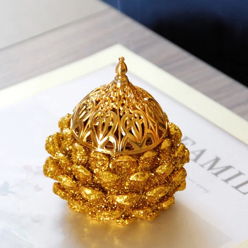 Handcrafted gold pine cone incense holder as home altar decoration with spiritual ambiance