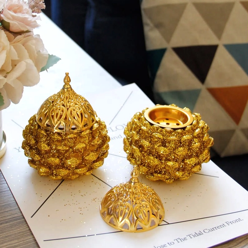 Gold pine cone incense holder showcasing handcrafted artisan quality with natural material variations