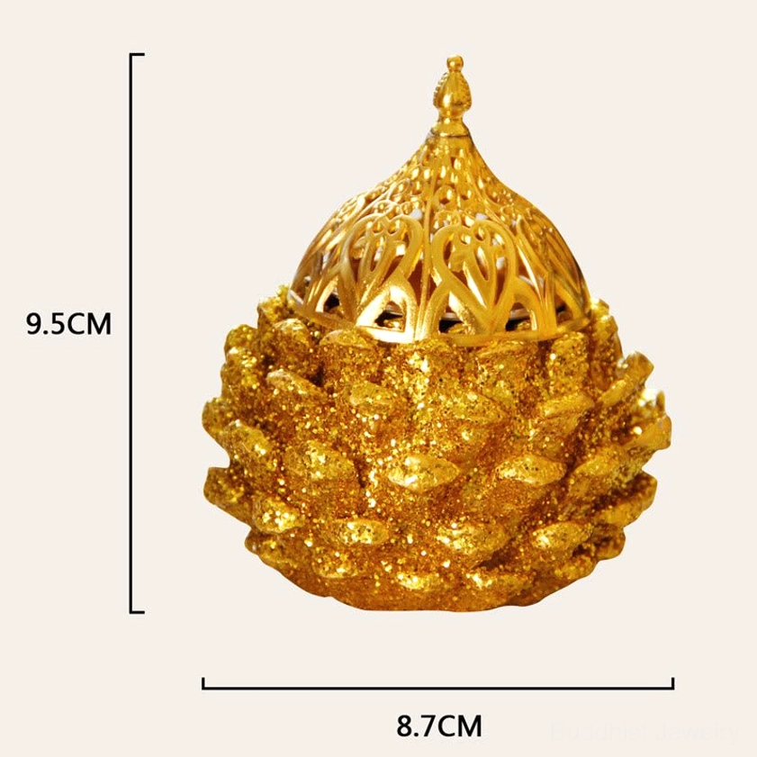 Gold pine cone incense holder as Buddhist ritual tool honoring spiritual traditions and Triple Gem