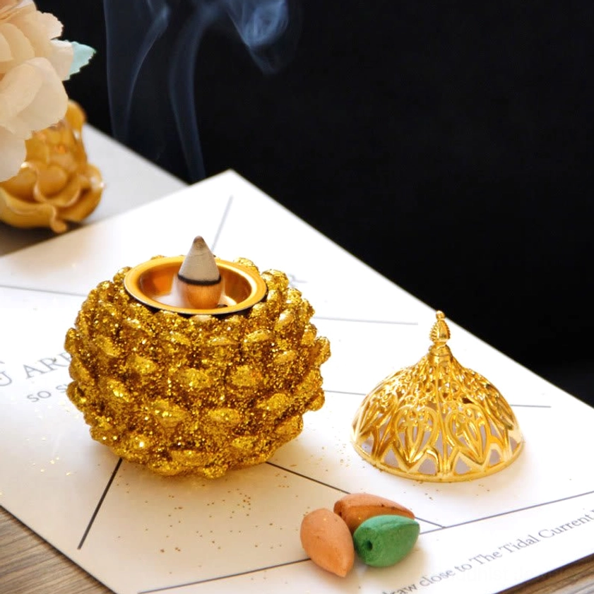 Luxury gift presentation of gold pine cone incense burner for spiritual seekers and meditation enthusiasts