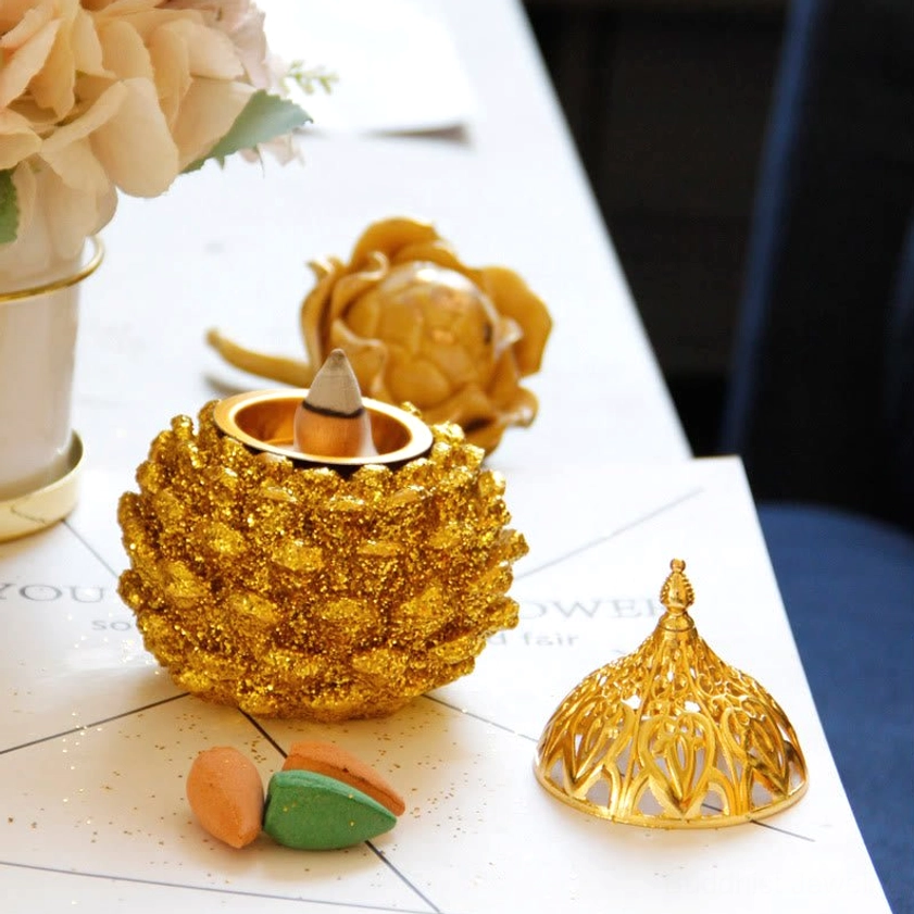 Pine cone-shaped incense burner set with removable lid and included backflow incense cones on decorated tabletop