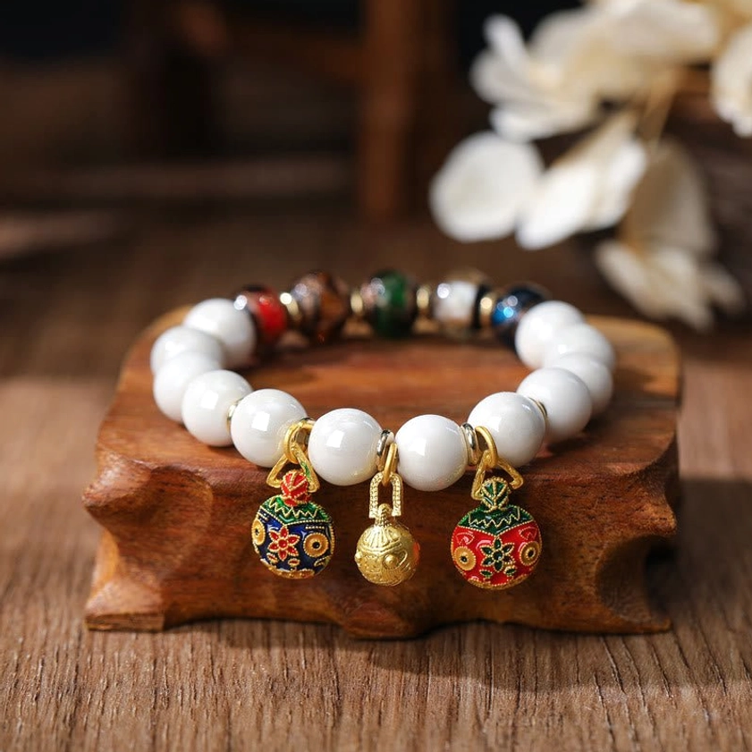 Gold Pixiu family bracelet with multicolored porcelain beads and enamel charm accents