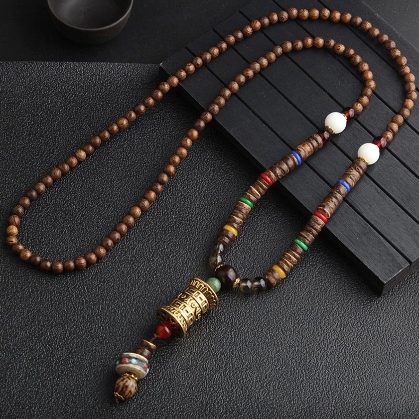 Gold prayer wheel pendant Tibetan Buddhist meditation necklace with brown wooden beads and sacred carved charm