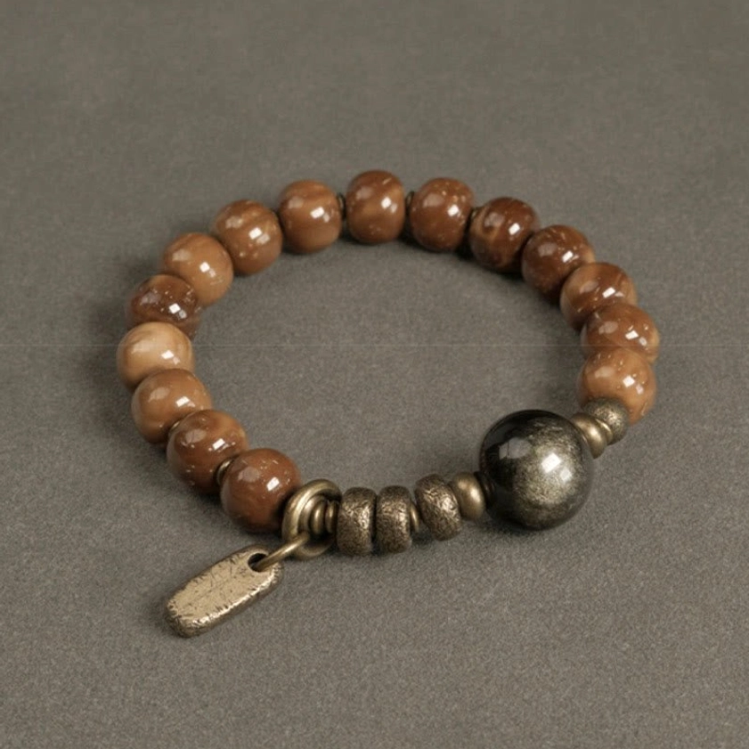 Gold sheen obsidian kuka seed bracelet with brass metal accent parts