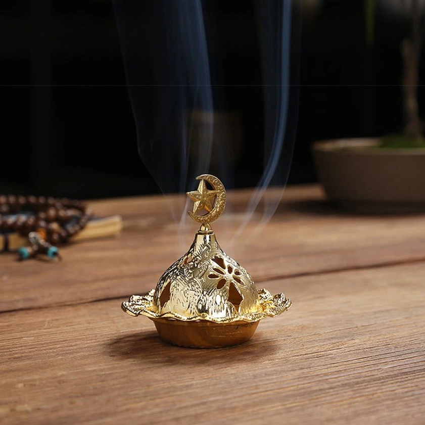 Gold star incense burner with moon and star finial design and hollow floral patterns