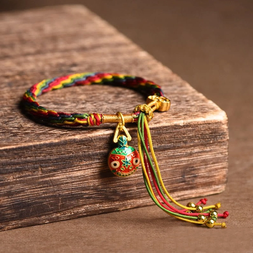 Gold swallowing beast mother family luck bracelet featuring single enamel charm with multi-color protective braided rope