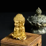 Golden Buddha statue fridge magnet left three-quarter view on wooden stand with incense holder