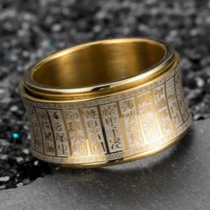 Golden Buddhist mantra spinner ring with engraved sacred script - top close-up view