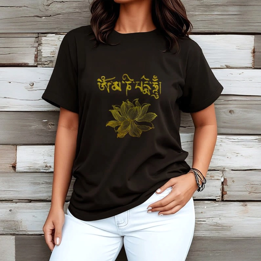 Model wearing black spiritual t-shirt with golden Sanskrit design paired with white jeans - Buddhist graphic tee styling idea