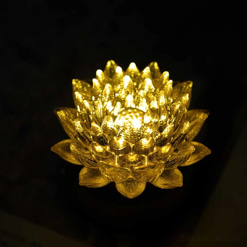 Golden lotus night light close-up with glowing petals on dark background, layered petal design detail