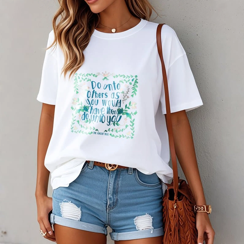 Woman wearing white Buddhist golden rule t-shirt with teal floral spiritual print front upper body view