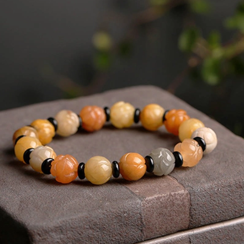 Golden Silk Jade Lotus Bracelet worn on wrist showing comfortable fit and natural jade luminosity in daylight