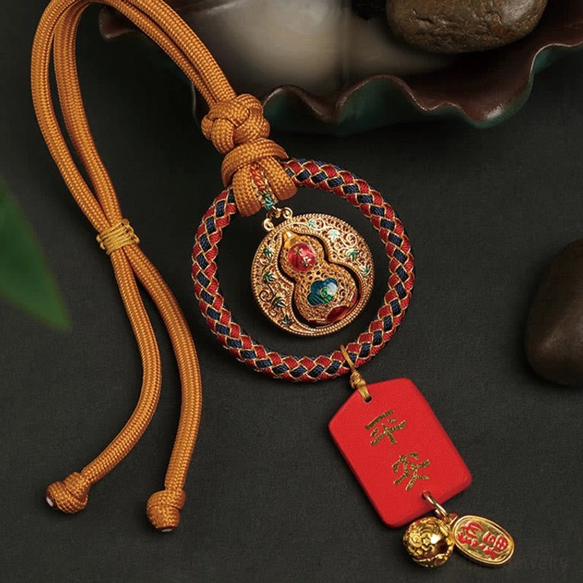 Gourd Fu character car hanging charm with braided rope, enamel gourd pendant, red Ping An protection tag, and gold trinkets - side top view