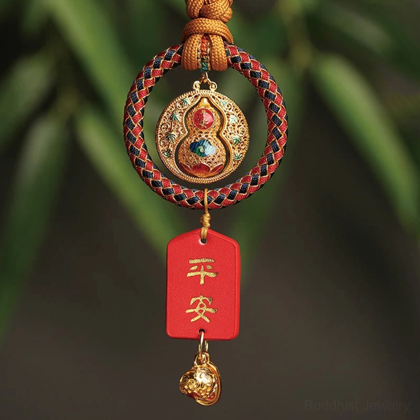 Buddhist gourd and Fu character car hanging ornament with natural rope loop and green foliage background