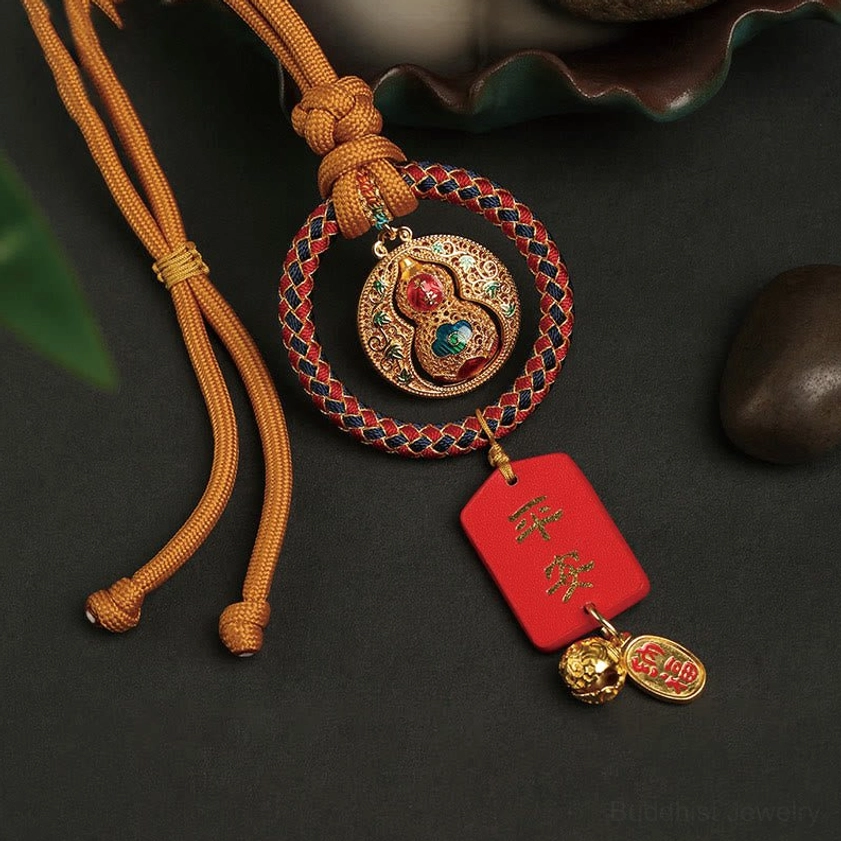 Protection charm gourd Fu character with braided rope and red Ping An safety tag low side angle view